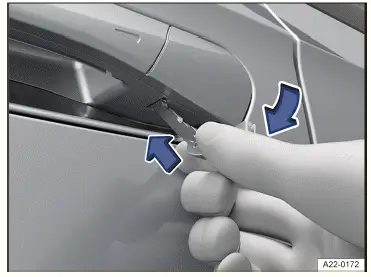 Fig. 1 Driver's door handle: prying off the cap.